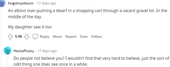 15. An albino man pushing a dwarf in a cart