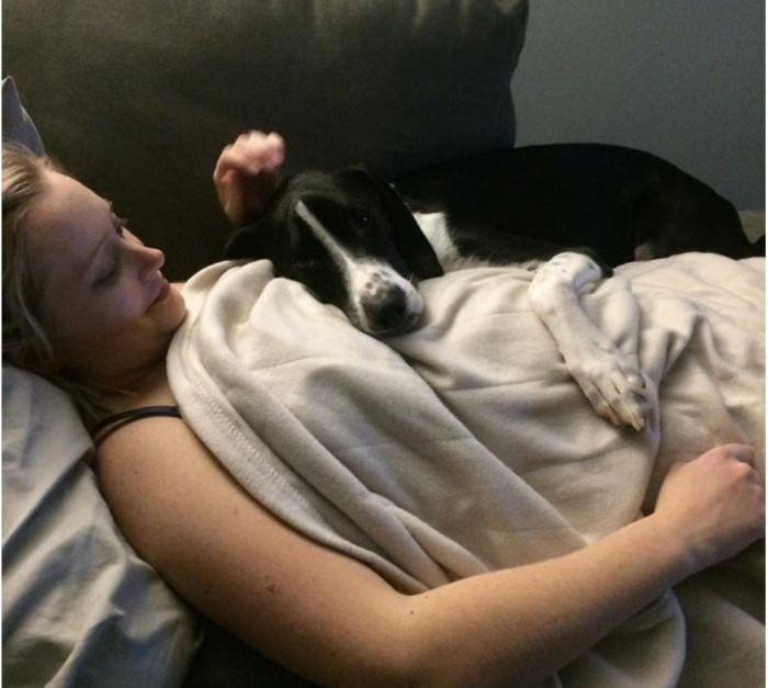 25. This cute whelp listens to the heartbeat of the baby by placing its ears on her stomach.