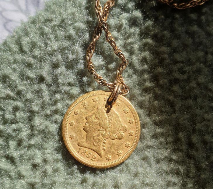 6. Redditor's mom found this 2.5 dollar gold coin from 1852 while gardening at their grandparents' house and made it back into the necklace it was intended to be made into