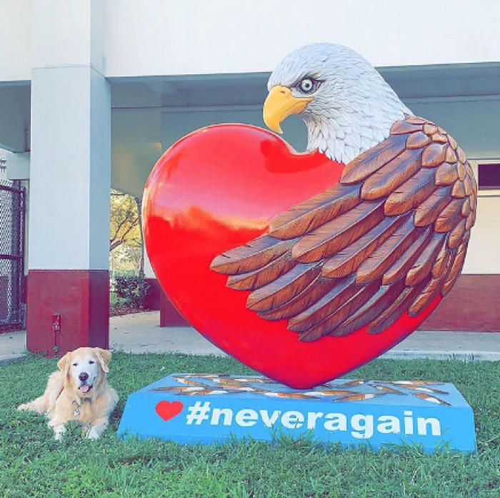 One of the therapy dogs with the statue commemorating the memory of those lost and serving as a reminder to never let something this horrible happen again.