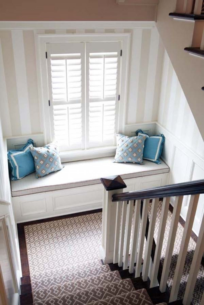 3. Turn your landing staircase into a cozy lounging area by putting a seat next to the window.