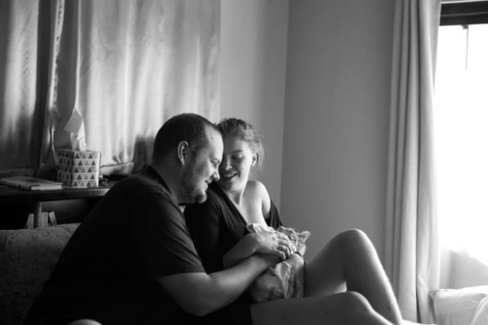 Lucy smiles beside the kitten during viral kitty maternity shoot, wrapped safely.