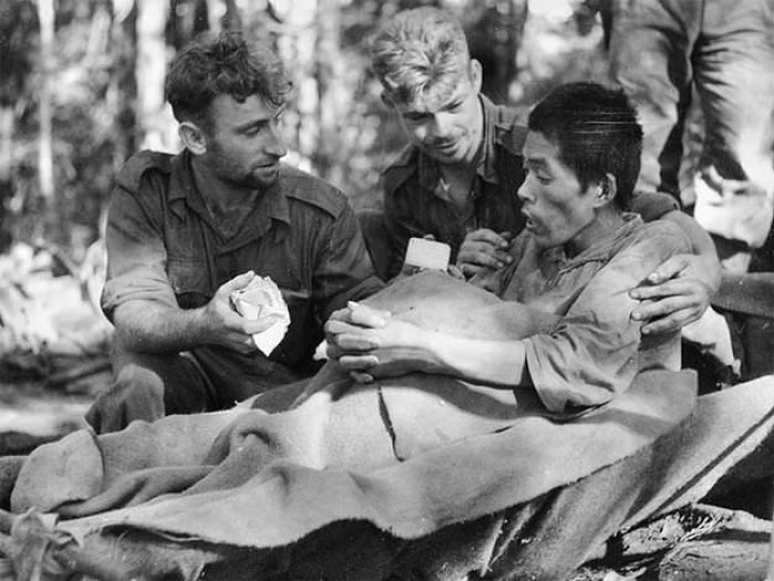 3. Australian stretcher bearers tend to a very sick Japanese soldier with Malaria in WWII in 1945.
