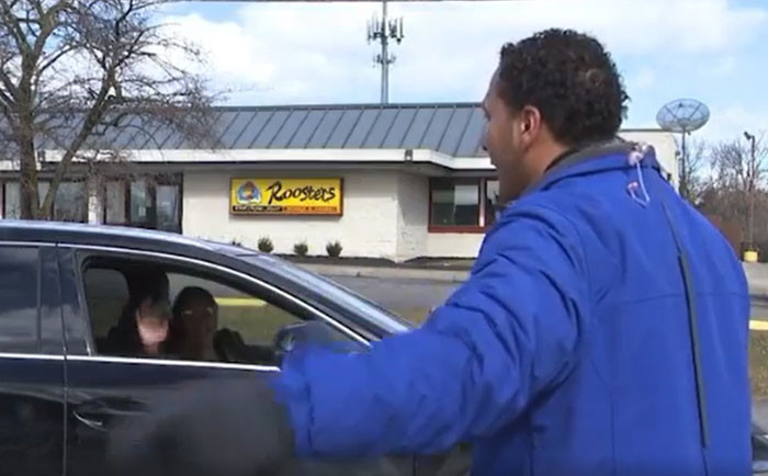 Myles' Mom, Sandi, gleefully waves and yells, 