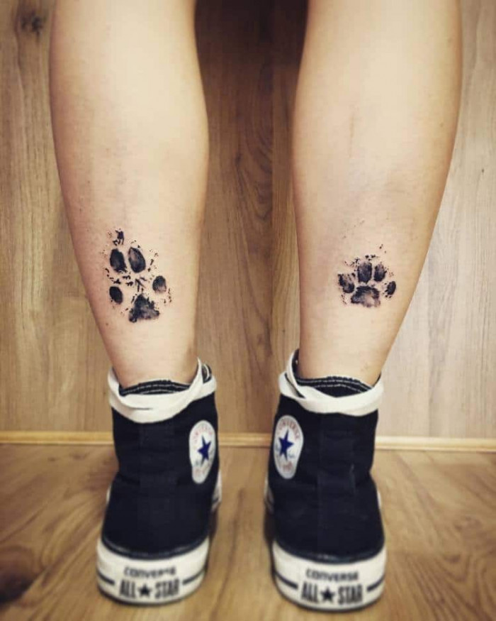 17. Paw tattoo on the back of both legs