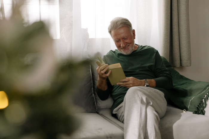 A grandpa reads The Night Before Christmas to the family.