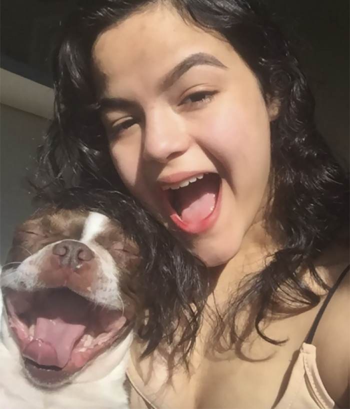 Dog and pet posed for a twinning selfie, unimpressed expression