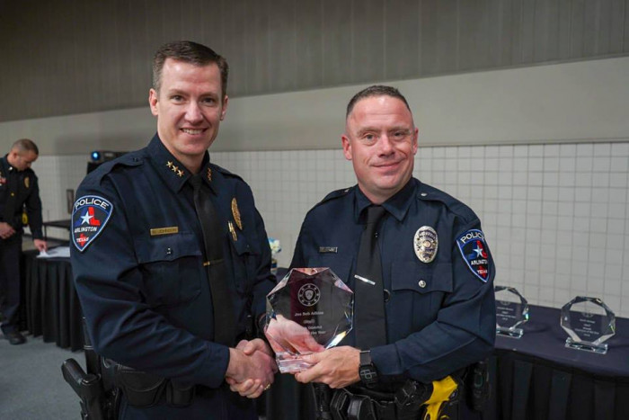 Two kittens nuzzle the officer’s hands, cuddling during their rescue.
