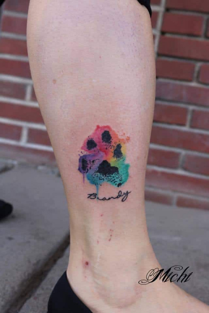 9. Paw with name tattoo