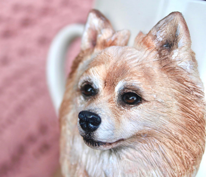 Hyper-realistic German Spitz and Bulldog polymer clay mugs displayed side by side