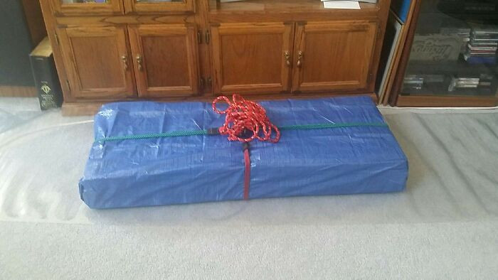 6. Another wrapping tip, especially for big and heavy gifts, is to use inexpensive materials like tarps and bungee cords.