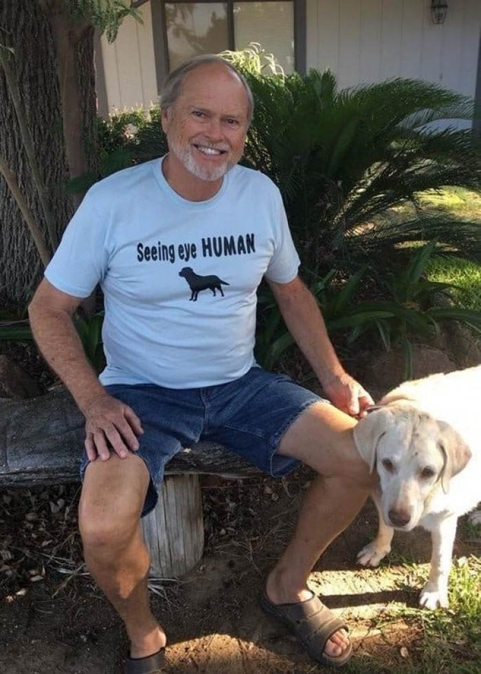 13. His human is guiding him around.