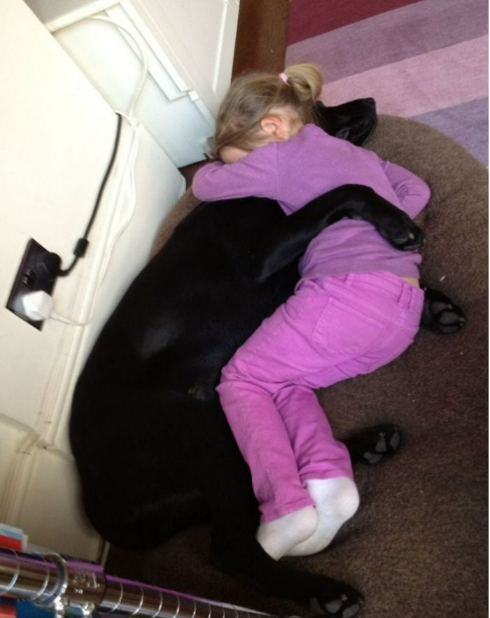 23. This little girl finds comfort in cuddling with her best friend after she returns from school.