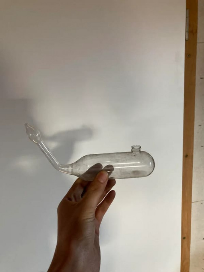 14. “A very light glass tube with a hole at the top and a thinner, upwards bending tube coming out from one side. Found in my grandpa‘s attic in Switzerland.”