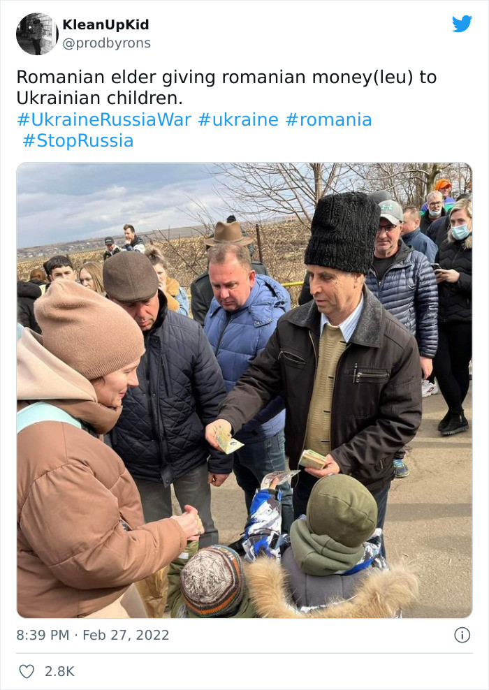 36. A Romanian lady is giving out her local currency to Ukrainian children for survival