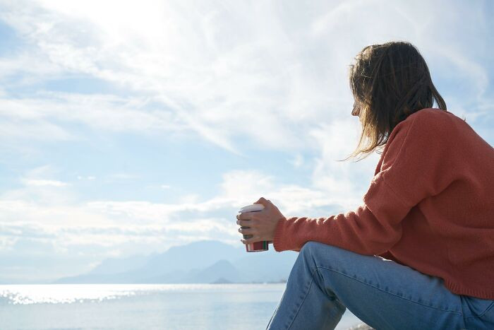 A girl was hanging out at the beach alone when suddenly a man passing by stared at her.