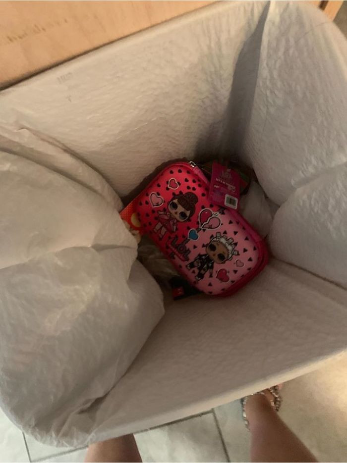 The L.O.L. pencil box sitting in the trash can