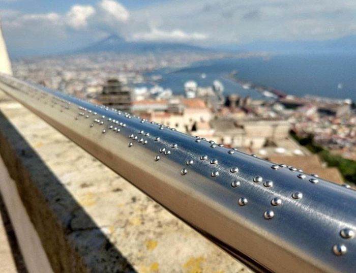 9. This Railing in Naples Has a Description of the View in Braille for Blind People.
