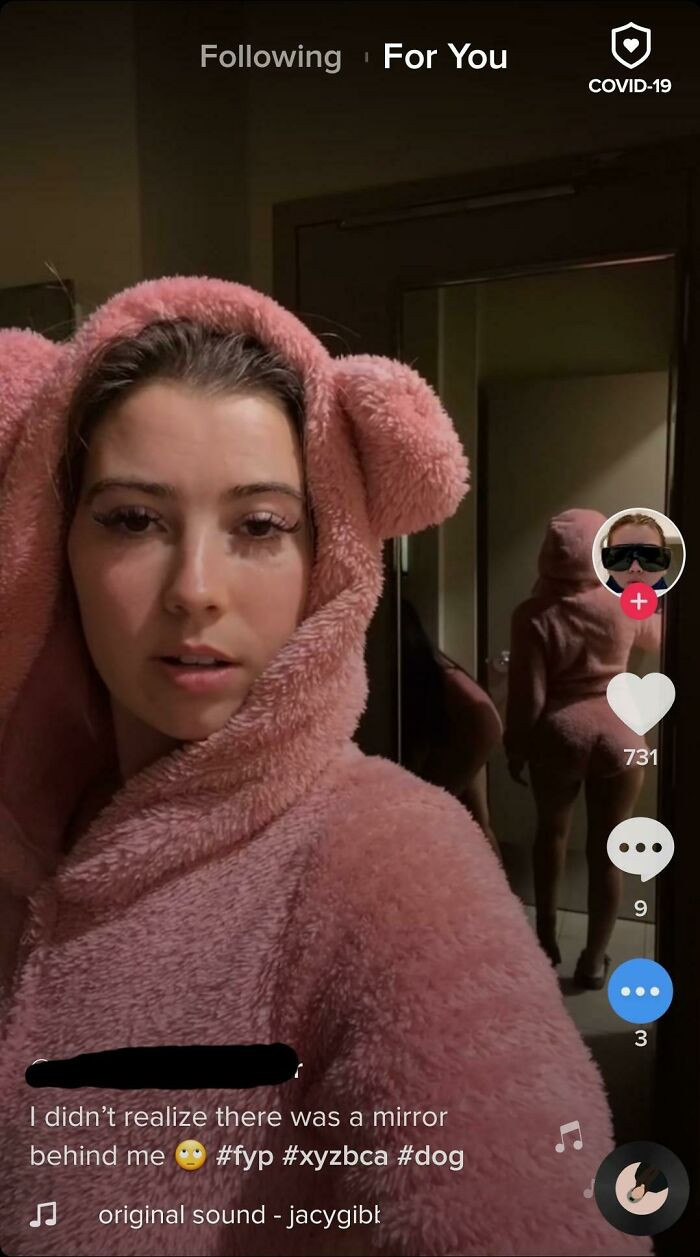 30. She is oblivious to her surroundings despite looking at them through a phone.