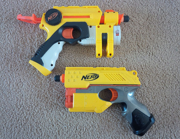 The cat got addicted to playing with the NERF gun.