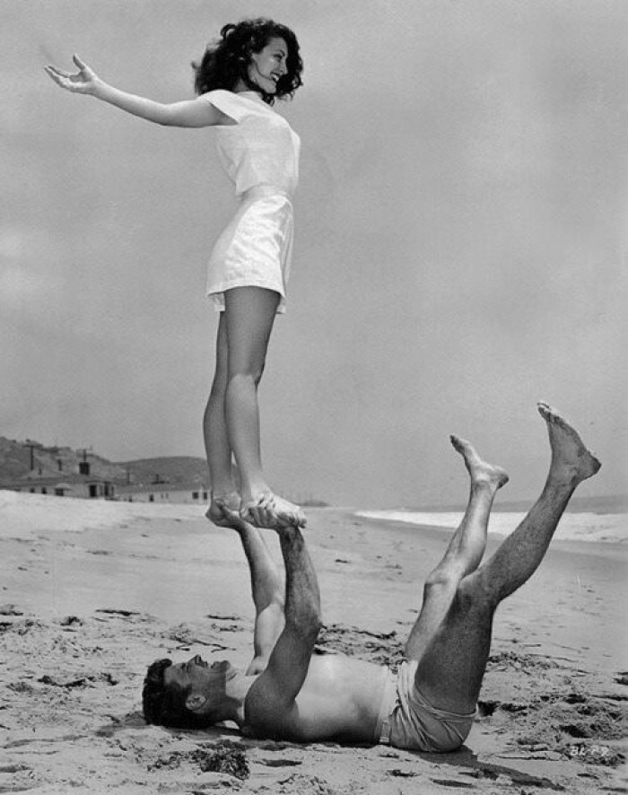 Ava Gardner and Burt Lancaster doing acro-yoga in 1946