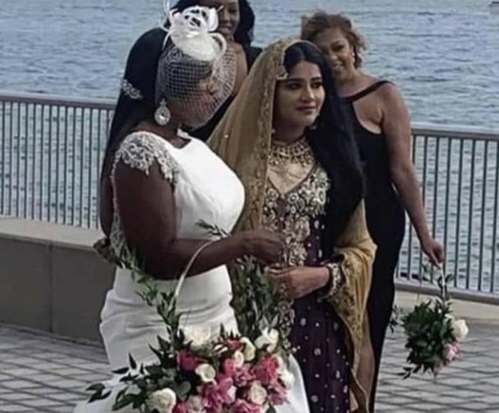 7. Two brides from two different cultures get married on the same day and takes pictures with each other