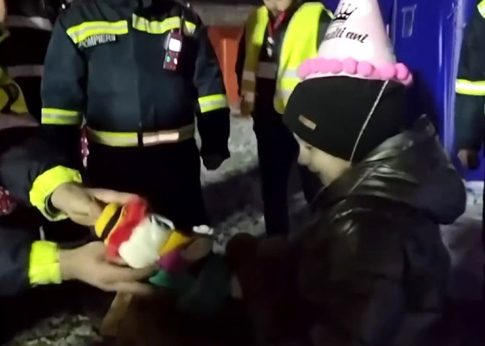 Arina receives an adorable little plushie as a gift from an officer.