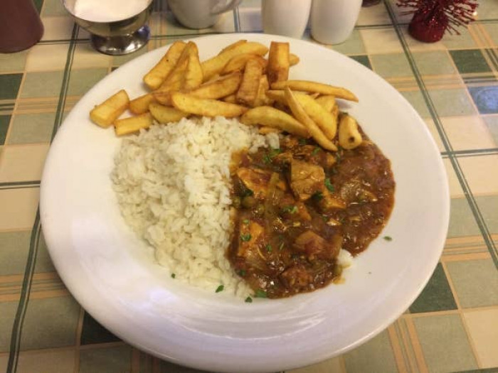 12. Traditional curry, rice, and chips on the side