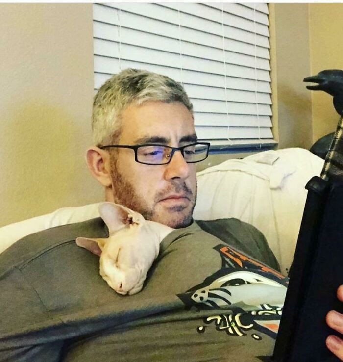 He fought against getting a hairless cat, but look at them now...inseparable!