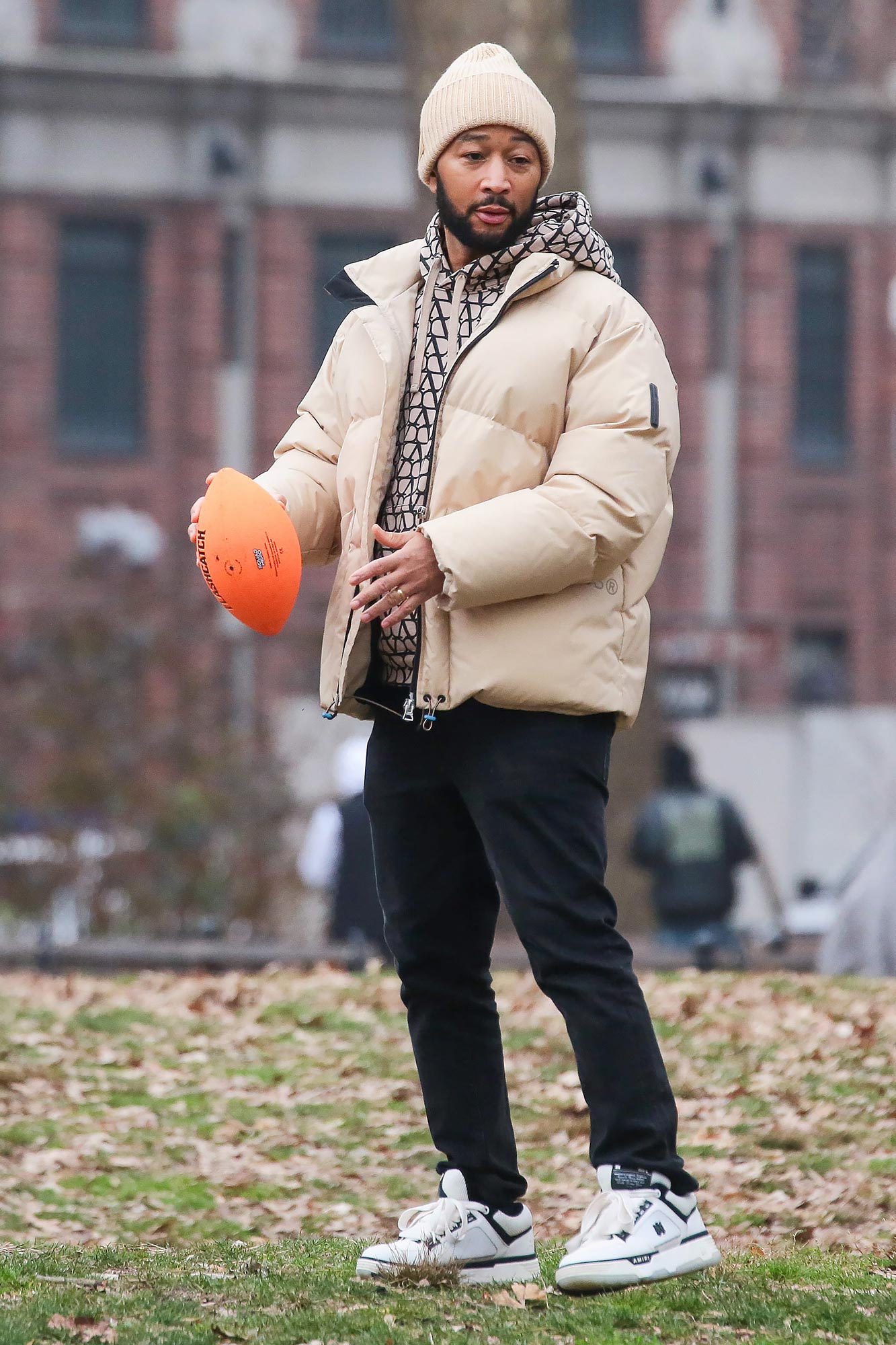1. John Legend tossing a football outdoors