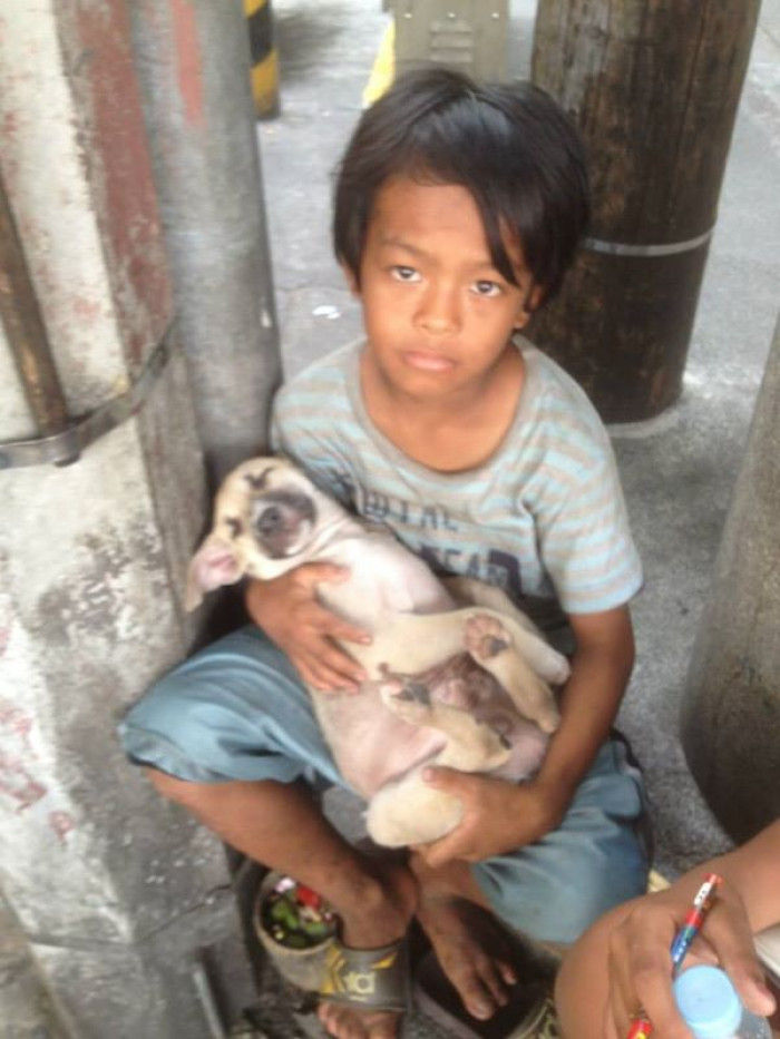 The boy’s name is Rommel, and he is 11 years old. His little puppy is named Badji