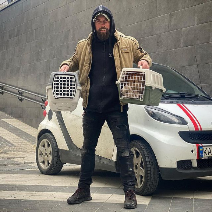 Alexei Surovtsev posing with a pair of rescued chinchillas