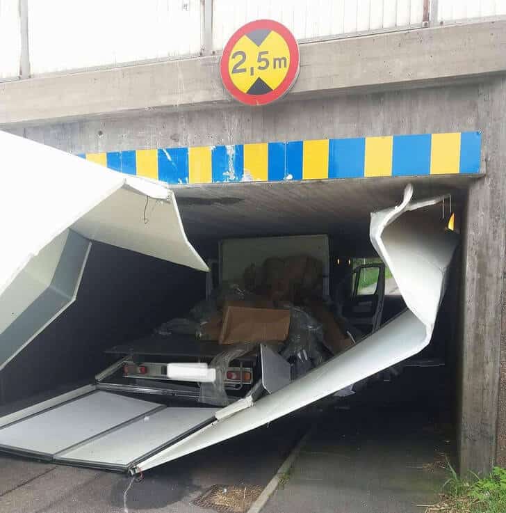 14. “Box truck hauling a classic car hit a bridge.”