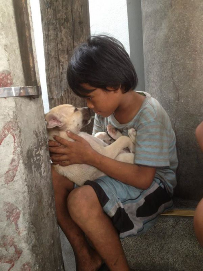 A little boy held a puppy in his arms and sang a lullaby to him