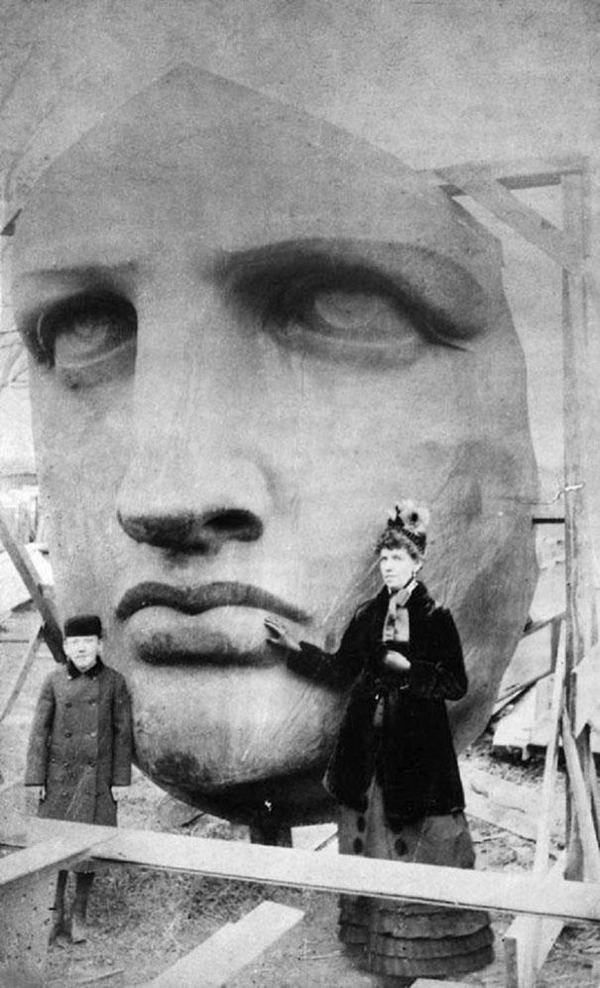 Iconic snapshots of individuals posing by the Statue of Liberty's face during her unveiling