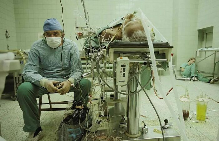 14. This photo shows Dr. Zbigniew Religa keeping watch on the vital signs of a patient after a 23 hour heart surgery he conducted in 1987.