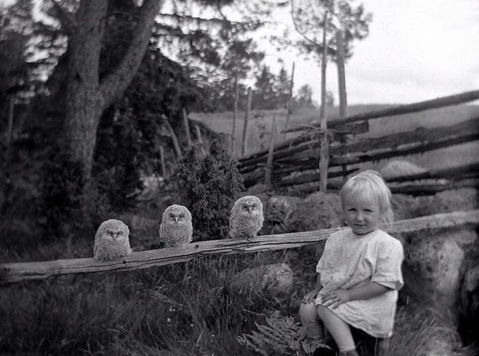 "A little girl with three owls, 1925."