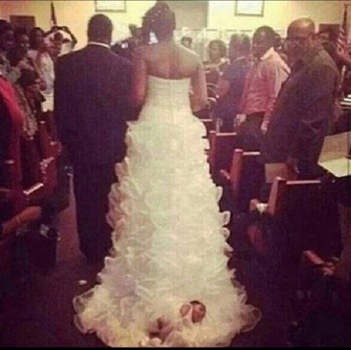 2. “Bride ties her 1 month baby to the back of her wedding dress.”