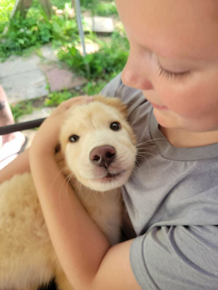 24. "My Nephew With His New Puppy"
