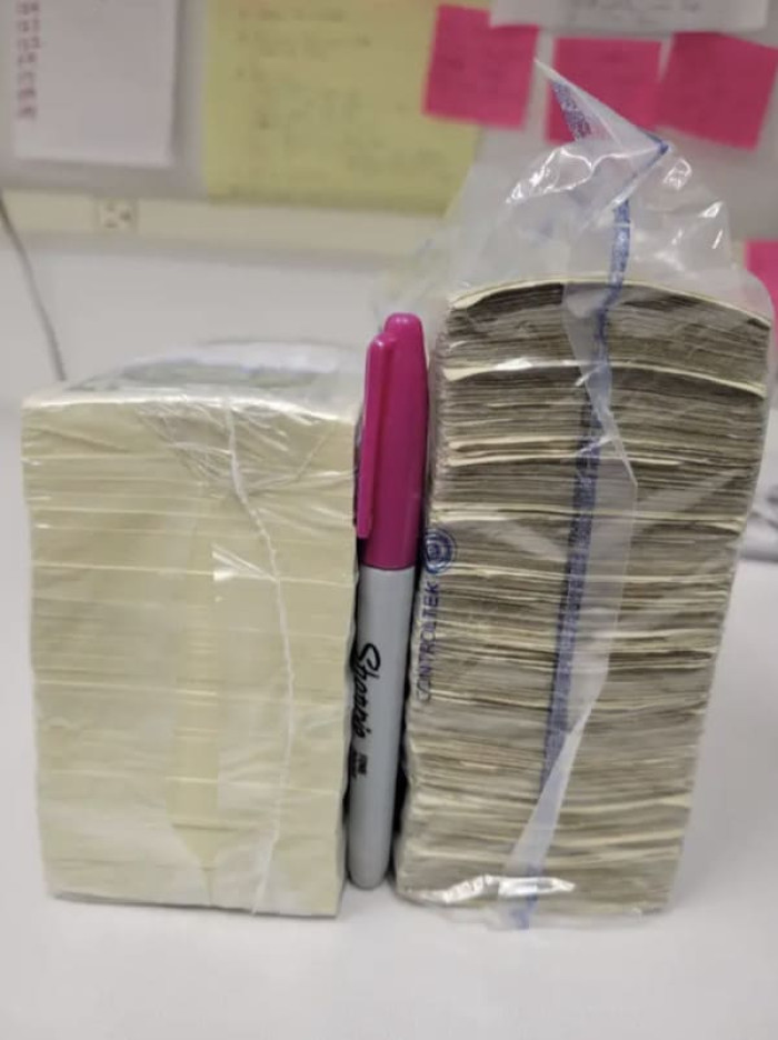 A stack of $1K in uncirculated $1 bills vs circulated ones.