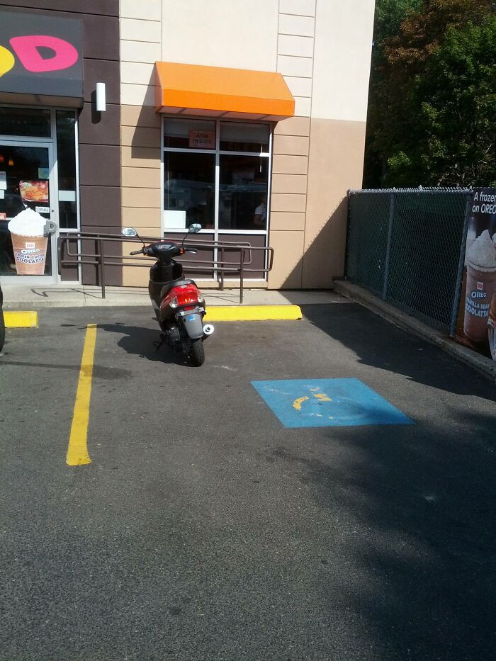 18. It's truly astonishing that this lady parked her scooter in a handicapped spot just to grab some Dunkin' Donuts and then left with her son on her lap. Incredible.