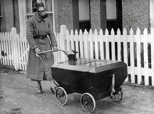 A woman taking her baby for a stroll in a gas-resistant baby carriage.