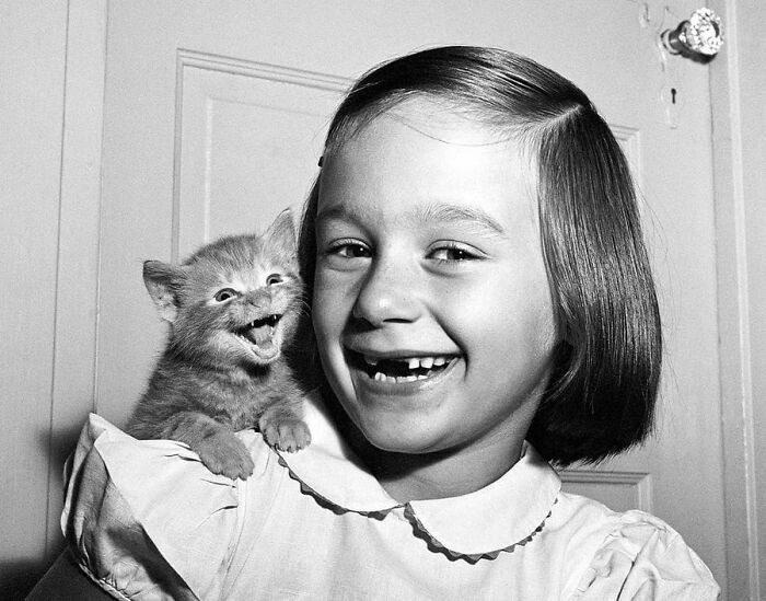 "A girl and her cat, 1955."