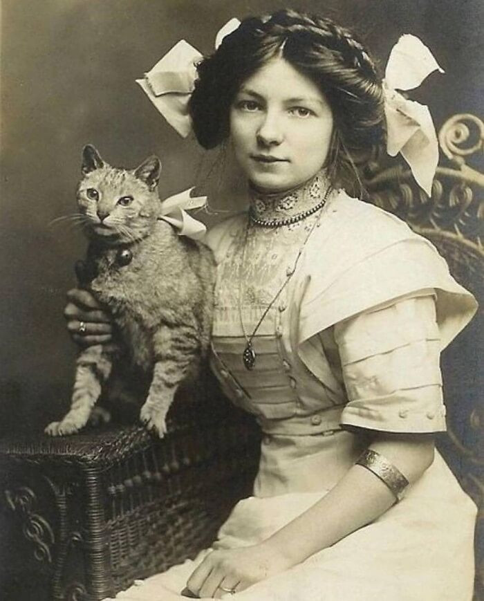 "A young girl and her cat, 1910."